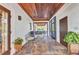 Covered outdoor patio with decorative flooring, seating area, and view of the outdoor living space at 9239 Impala Cir, Port Charlotte, FL 33981