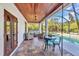 Covered outdoor patio featuring seating area, dining table, decorative flooring and view of the pool at 9239 Impala Cir, Port Charlotte, FL 33981