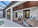 Covered outdoor patio featuring comfortable wicker furniture, ceiling fan, and decorative wood ceiling at 9239 Impala Cir, Port Charlotte, FL 33981