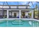 Screened pool area with a covered patio with multiple seating areas at 9239 Impala Cir, Port Charlotte, FL 33981