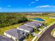 Beautiful aerial view of single-Gathering homes with manicured lawns and a serene pond in the distance at 10995 Pinot Dr, Venice, FL 34293