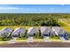 Aerial view of houses, showcasing community and proximity to lush green forests at 10995 Pinot Dr, Venice, FL 34293