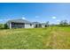 View of back of homes in the neighborhood from the spacious lawn at 10995 Pinot Dr, Venice, FL 34293