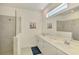 Bright bathroom with double vanity, large mirror, shower, and contemporary finishes for a modern appeal at 10995 Pinot Dr, Venice, FL 34293