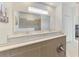 Well-lit bathroom showcasing a double vanity, a large mirror reflecting the shower, and a clean, modern design at 10995 Pinot Dr, Venice, FL 34293