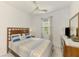 Cozy bedroom with a ceiling fan, a window with blinds, and a comfortable bed with decorative pillows at 10995 Pinot Dr, Venice, FL 34293