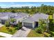 Beautiful new home with modern design, paver driveway, and lush landscaping at 10995 Pinot Dr, Venice, FL 34293