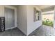 Welcoming front entrance featuring a gray door, decorative welcome sign, and tiled porch at 10995 Pinot Dr, Venice, FL 34293