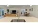 Open concept living featuring kitchen island and sink looking into living and dining area at 10995 Pinot Dr, Venice, FL 34293