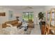 Cozy living room featuring a leather couch and outdoor views at 10995 Pinot Dr, Venice, FL 34293