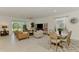 Bright living space with a leather couch, open dining area, and sliding glass doors to the outdoor space at 10995 Pinot Dr, Venice, FL 34293