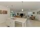 Open concept living featuring island sink, view into living area, and dining area at 10995 Pinot Dr, Venice, FL 34293