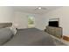 Bright main bedroom featuring ceiling fan, neutral paint, window with blinds, dresser, and television at 10995 Pinot Dr, Venice, FL 34293