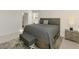 Bright main bedroom featuring ceiling fan, neutral paint, window with blinds, gray accents, and walk-in closet at 10995 Pinot Dr, Venice, FL 34293