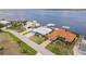 Aerial view of waterfront neighborhood showcasing canal access, landscaping, and nearby water views at 12596 Bacchus Rd, Port Charlotte, FL 33981