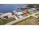 An aerial view showcases the waterfront home, boat lift and neighborhood on the open water at 12596 Bacchus Rd, Port Charlotte, FL 33981