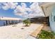 Backyard with white gravel, landscaping, and a view of the screened pool at 12596 Bacchus Rd, Port Charlotte, FL 33981
