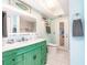 Bathroom featuring a bright vanity with a green cabinet base and a door leading to the outside at 12596 Bacchus Rd, Port Charlotte, FL 33981
