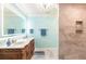 Light-filled bathroom featuring a double sink vanity with marble countertops and an intricately carved wooden base at 12596 Bacchus Rd, Port Charlotte, FL 33981