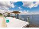 View of the dock featuring boat lift, canopy, and the serene water views in the background at 12596 Bacchus Rd, Port Charlotte, FL 33981