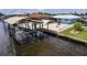 An aerial view showing the boat lift, outdoor space, and RV parking next to the home at 12596 Bacchus Rd, Port Charlotte, FL 33981