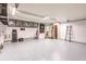 Well lit garage featuring epoxy floors, overhead storage, and an open doorway to the house at 12596 Bacchus Rd, Port Charlotte, FL 33981