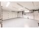 Bright and airy garage with epoxy flooring, white doors, garage door, and lots of storage at 12596 Bacchus Rd, Port Charlotte, FL 33981