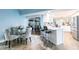 Eat-in kitchen featuring white cabinets, bar seating, stainless appliances and a lovely breakfast nook at 12596 Bacchus Rd, Port Charlotte, FL 33981