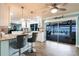 Modern kitchen with gray upholstered bar chairs, sleek countertops, and an outdoor pool view at 12596 Bacchus Rd, Port Charlotte, FL 33981