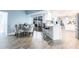Eat-in kitchen featuring white cabinets, bar seating, stainless appliances and a lovely breakfast nook at 12596 Bacchus Rd, Port Charlotte, FL 33981