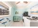 Bright laundry room with a new washer and dryer, and quirky ocean-themed decorations at 12596 Bacchus Rd, Port Charlotte, FL 33981