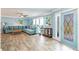 Light and airy living room with blue walls, tile floors, comfortable sofa and views at 12596 Bacchus Rd, Port Charlotte, FL 33981