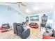 Bright living room featuring unique pinball machines, comfy seating and light wood-look floors at 12596 Bacchus Rd, Port Charlotte, FL 33981