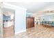 Bright, open-concept living space featuring tile floors, a blue paint scheme, and an open view of the kitchen at 12596 Bacchus Rd, Port Charlotte, FL 33981