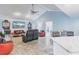 Spacious living area adjacent to kitchen, with tiled floors and unique decor at 12596 Bacchus Rd, Port Charlotte, FL 33981