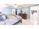 Bedroom featuring a decorative bed, lamps and ensuite bathroom at 12596 Bacchus Rd, Port Charlotte, FL 33981