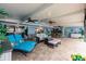 Beautiful covered patio with tile floors, multiple seating areas, ceiling fans, and coastal decor at 12596 Bacchus Rd, Port Charlotte, FL 33981
