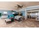 Comfortable covered patio area with tile flooring, ceiling fans, and multiple seating arrangements at 12596 Bacchus Rd, Port Charlotte, FL 33981