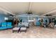 Large, covered patio area with tile floors, ceiling fans, and multiple seating arrangements at 12596 Bacchus Rd, Port Charlotte, FL 33981