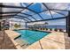An inviting, screened pool overlooking waterfront with boat dock at 12596 Bacchus Rd, Port Charlotte, FL 33981