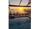 Sunset view from the pool looking out onto the dock at 12596 Bacchus Rd, Port Charlotte, FL 33981