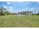 View of the backyard showing the house and an unfilled pool at 13972 Chesswood Ln, Port Charlotte, FL 33981