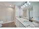 Bathroom featuring double sinks, white cabinets, and modern fixtures at 13972 Chesswood Ln, Port Charlotte, FL 33981