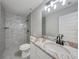 Bathroom with glass shower, modern vanity with marbled top and sleek faucet at 13972 Chesswood Ln, Port Charlotte, FL 33981