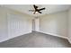 Bedroom with a closet, neutral walls, new floors, a fan, and modern doors at 13972 Chesswood Ln, Port Charlotte, FL 33981