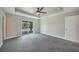 Spacious bedroom with tray ceiling, ceiling fan and sliding glass doors to patio at 13972 Chesswood Ln, Port Charlotte, FL 33981