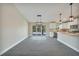 Dining area with elegant lighting fixtures, neutral color palette, and seamless flow to the kitchen at 13972 Chesswood Ln, Port Charlotte, FL 33981