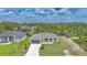 Charming single-story home with a well-manicured lawn, grey siding, and a paved driveway at 13972 Chesswood Ln, Port Charlotte, FL 33981