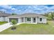 Well-maintained one-story home with grey exterior, well-kept lawn and two car attached garage at 13972 Chesswood Ln, Port Charlotte, FL 33981