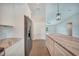 Open-concept kitchen with stainless steel refrigerator and long island at 13972 Chesswood Ln, Port Charlotte, FL 33981